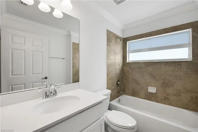 a bathroom with a sink a toilet and bathtub