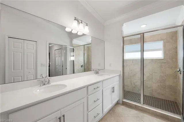 a bathroom with a double vanity sink and a mirror