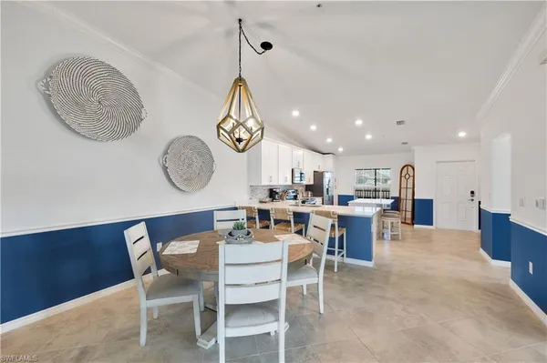 a dining room with wooden floor a glass table and chairs