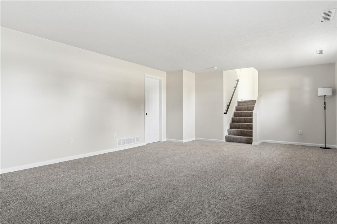 1353 Foust Road Xenia, OH 45385 - Photo 48 of 50 This versatile open-plan room features soft carpeting and convenient staircase access.