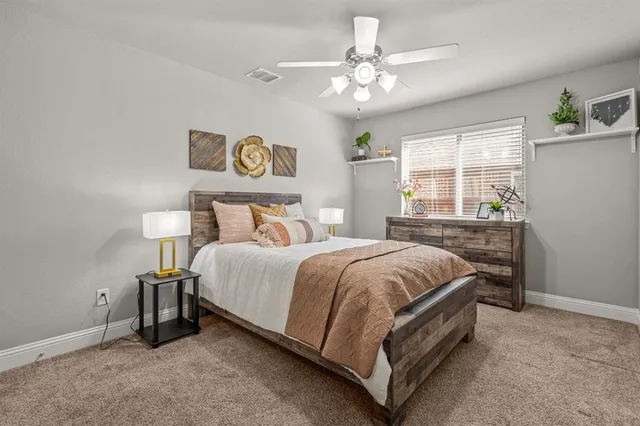 a bed sitting in a bedroom next to a window