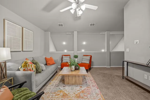 a living room with furniture and a chandelier