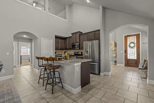 a kitchen with stainless steel appliances a refrigerator and a stove top oven