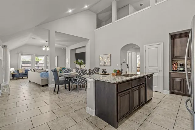 a kitchen with sink cabinets and dining table view