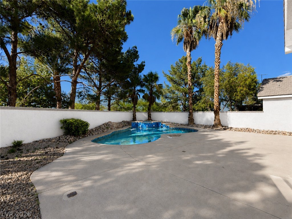1908 Thunder Ridge Circle Henderson, NV 89012 - Photo 3 of 28 An inviting backyard oasis offers a sparkling pool and a low-maintenance landscape.