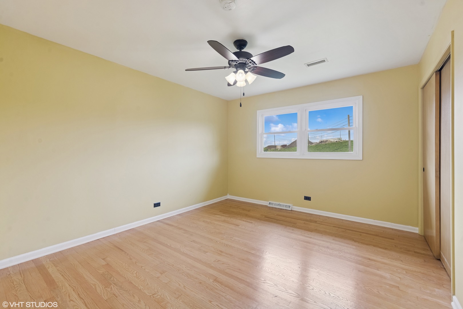 1826 Coolidge Avenue Berkeley, IL 60163 - Photo 9 of 15 an empty room with a window and a fan