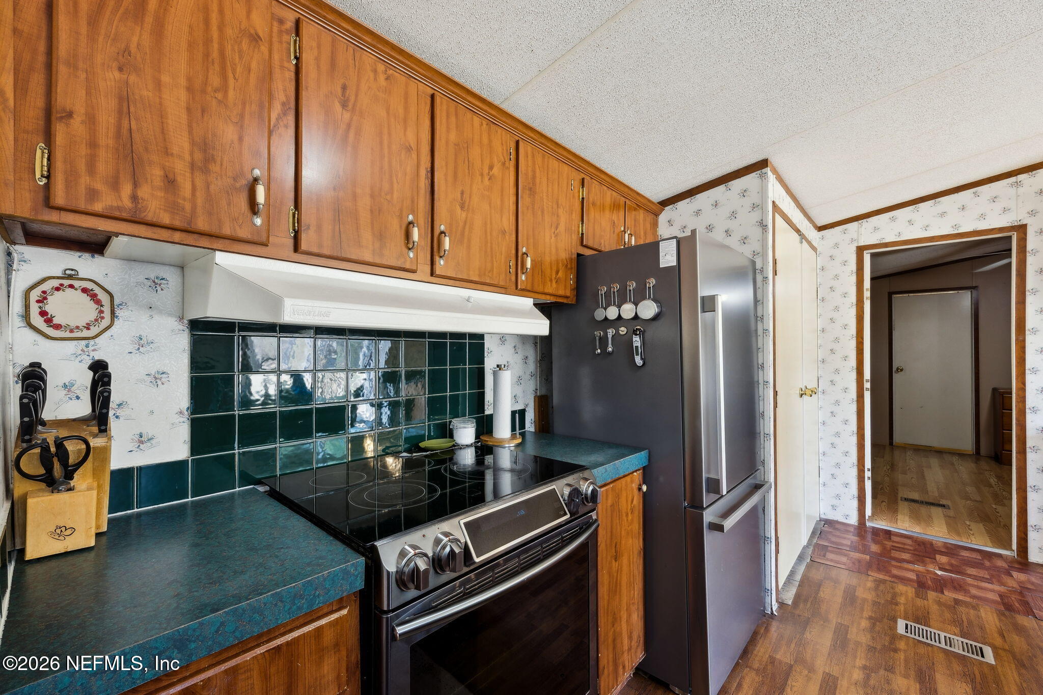 54002 Trooper Court Callahan, FL 32011 - Photo 15 of 56 a kitchen with stainless steel appliances granite countertop a refrigerator and a stove top oven