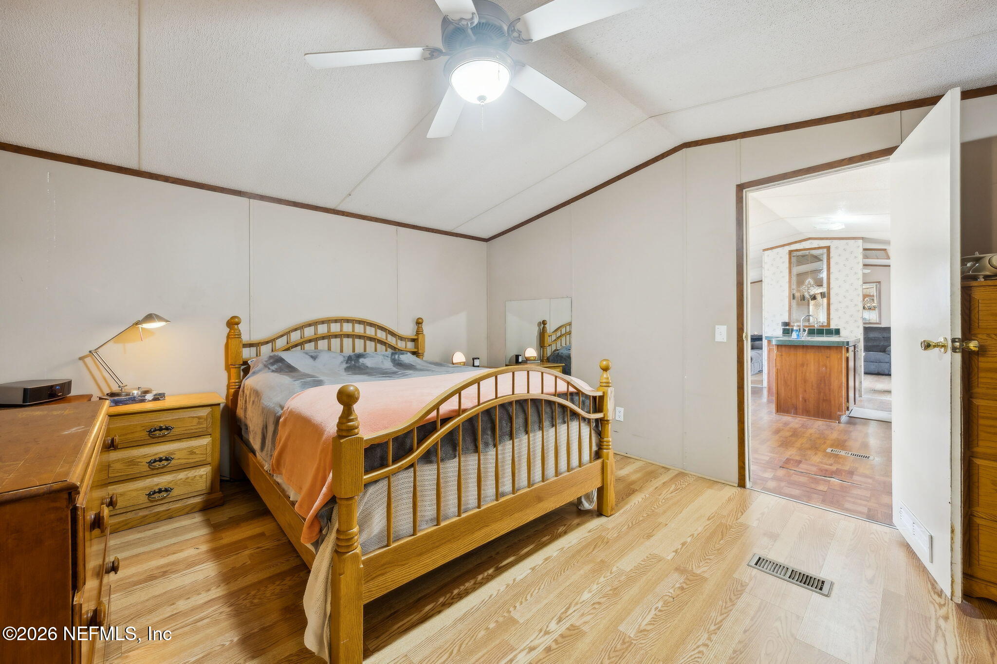 54002 Trooper Court Callahan, FL 32011 - Photo 23 of 56 a bedroom with a bed and a chandelier