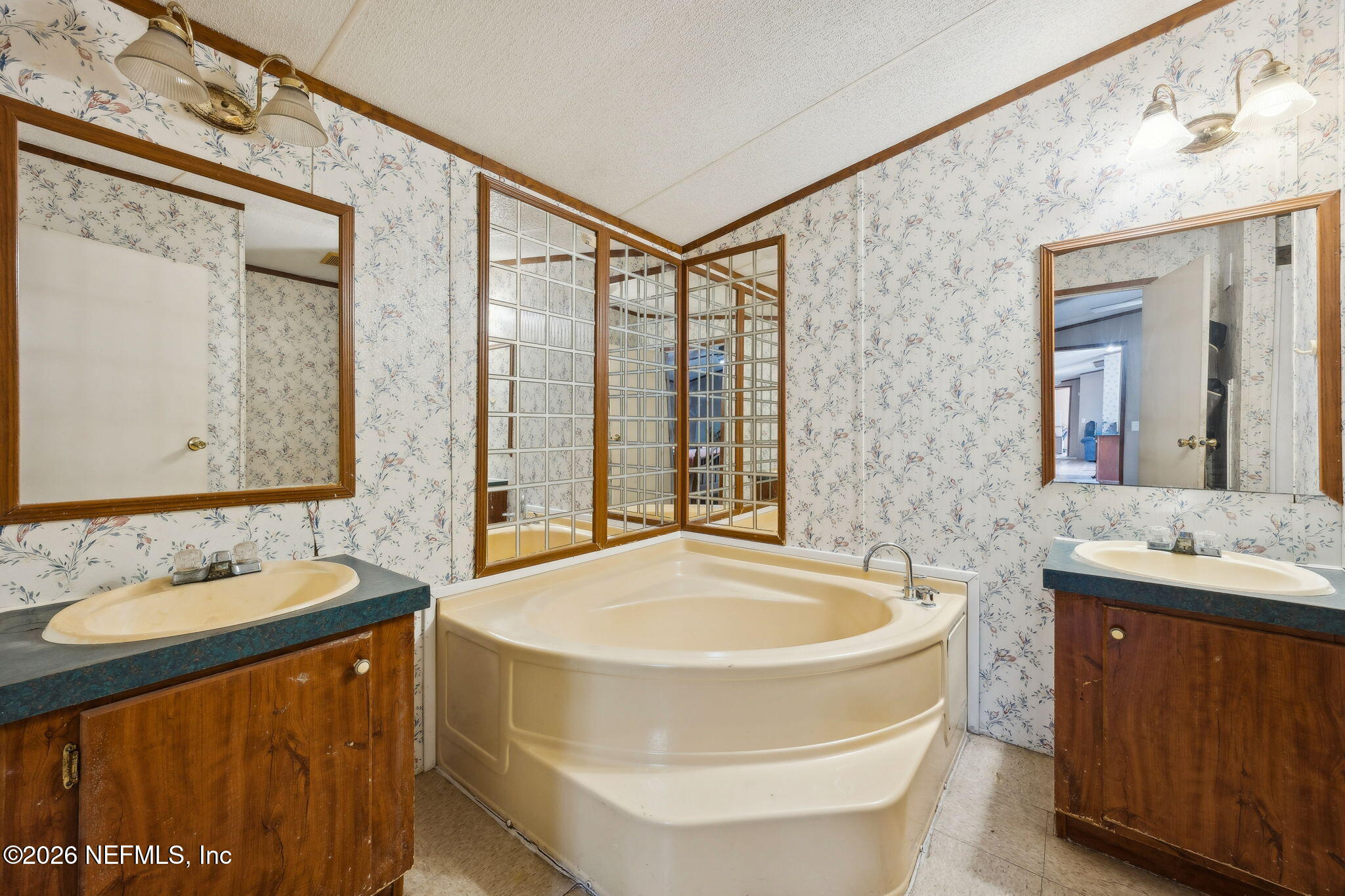 54002 Trooper Court Callahan, FL 32011 - Photo 25 of 56 a bathroom with a tub sink and mirror