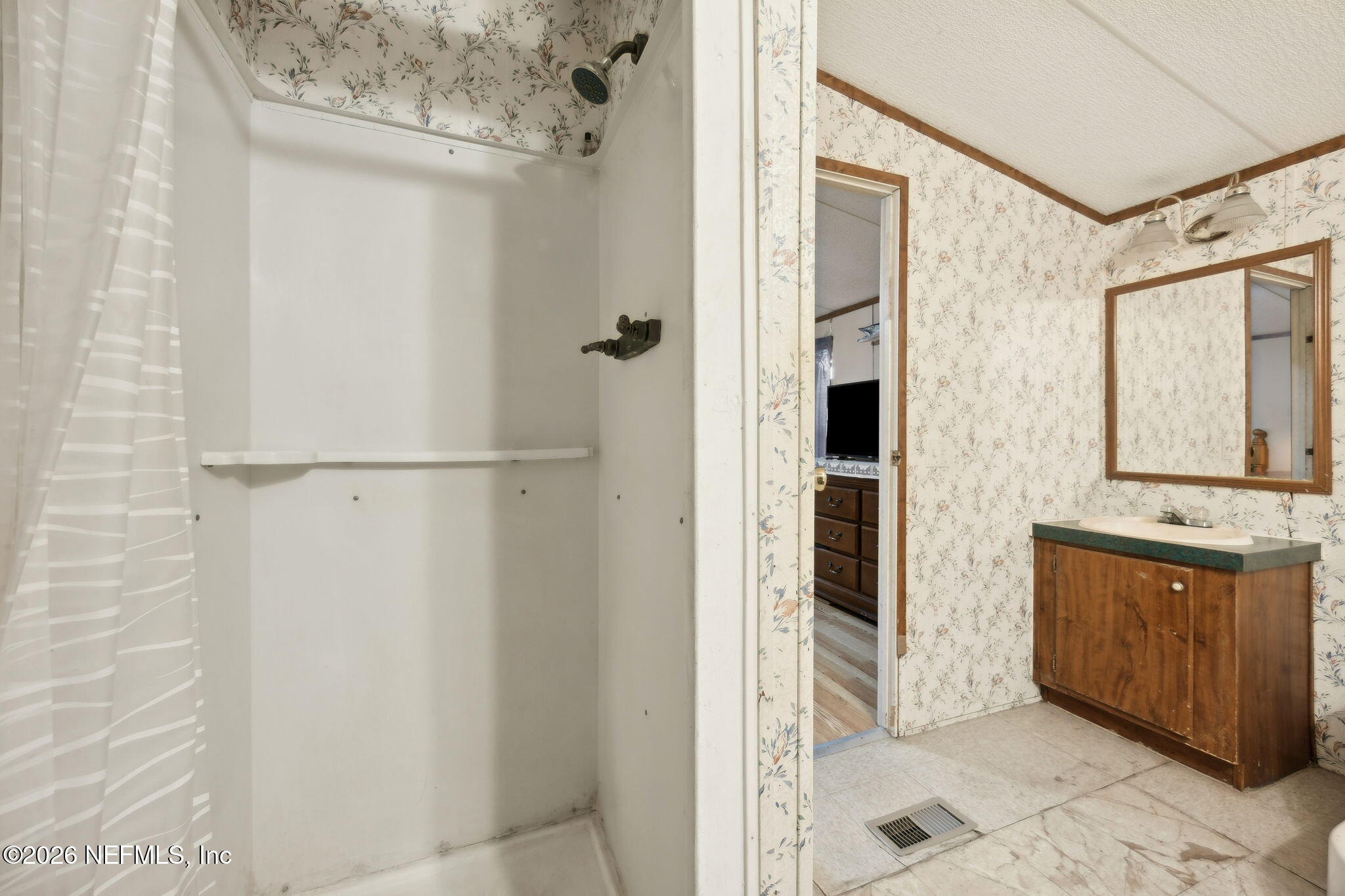 54002 Trooper Court Callahan, FL 32011 - Photo 26 of 56 a bathroom with a tub sink and mirror