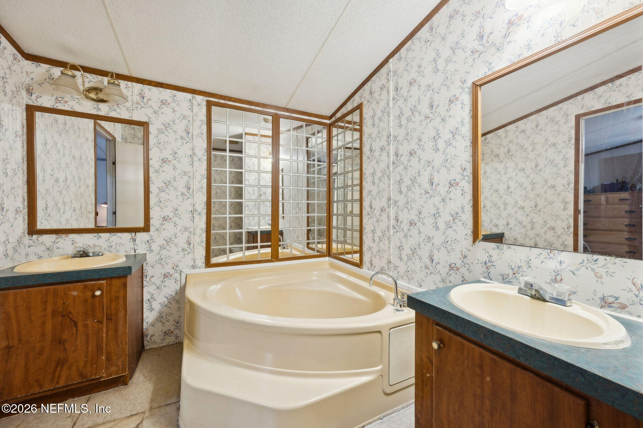 54002 Trooper Court Callahan, FL 32011 - Photo 27 of 56 a bathroom with a granite countertop sink and a bathtub