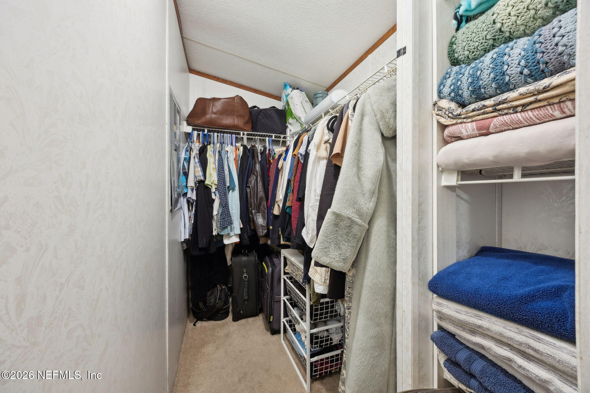 54002 Trooper Court Callahan, FL 32011 - Photo 28 of 56 a view of walk in closet with clothes and shoes