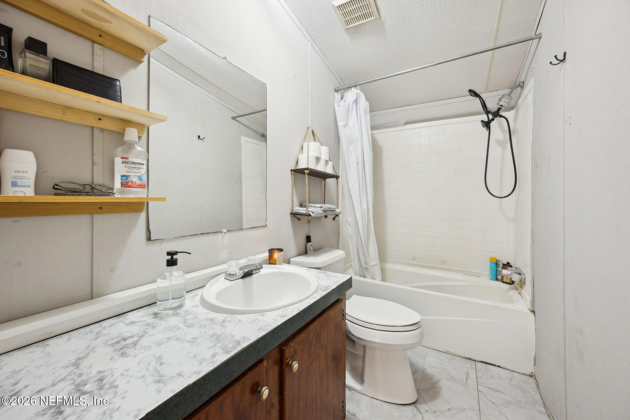 54002 Trooper Court Callahan, FL 32011 - Photo 32 of 56 a bathroom with a granite countertop sink toilet and shower