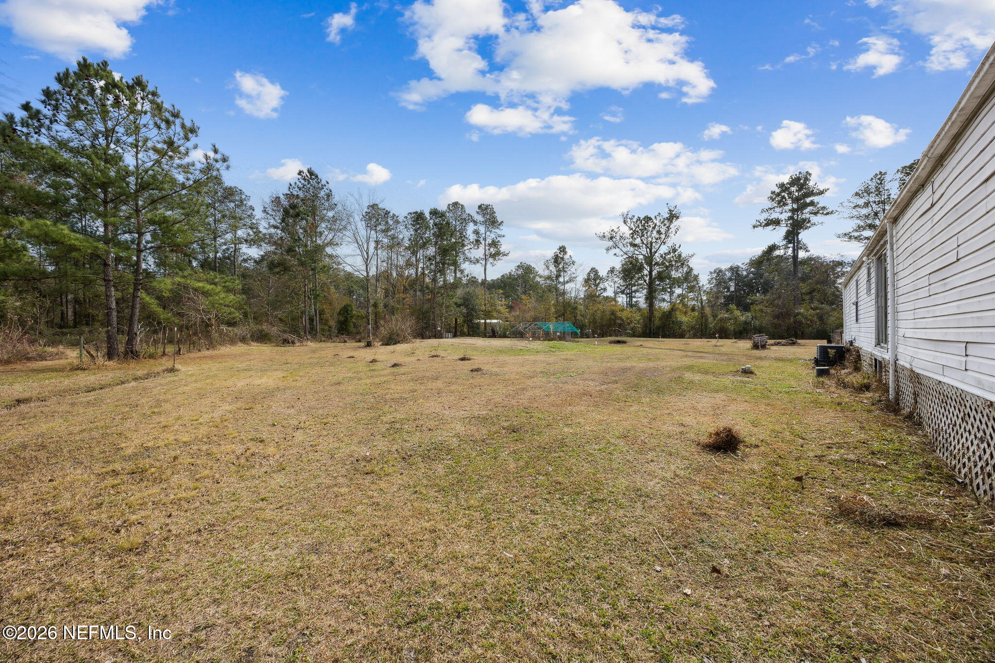 54002 Trooper Court Callahan, FL 32011 - Photo 37 of 56 a view of a field with trees in the background
