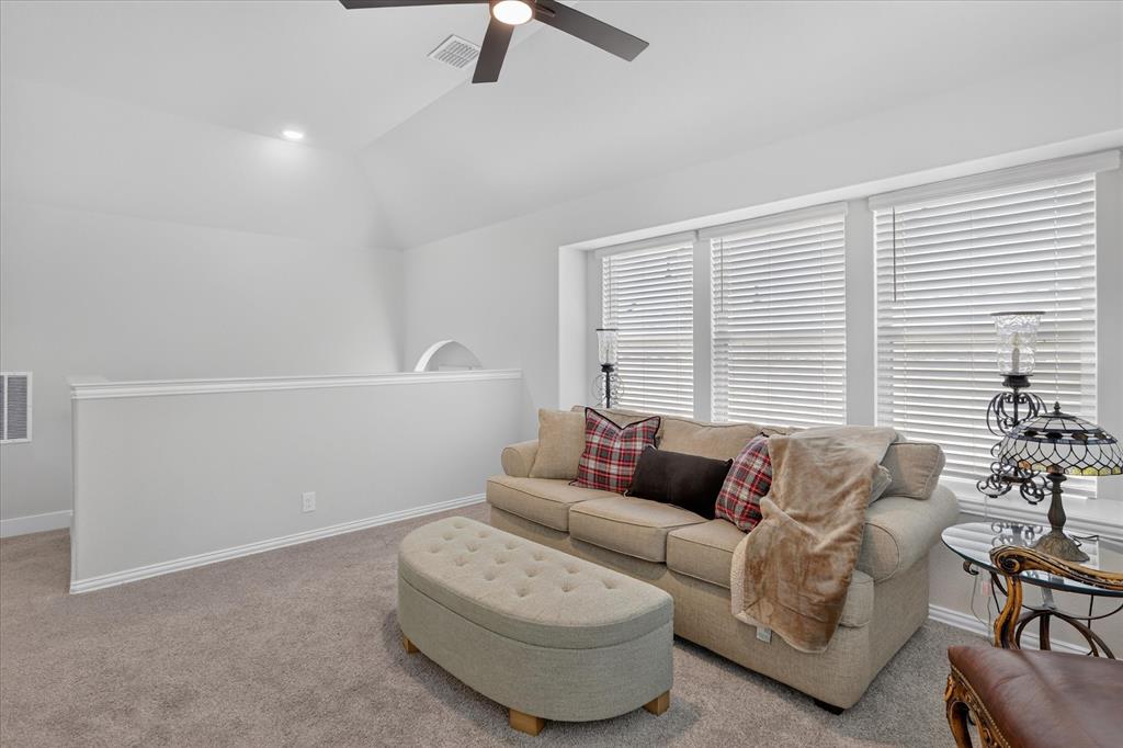 833 Godley Ranch Godley, TX 76044 - Photo 25 of 31 Carpeted secondary living space featuring a vaulted ceiling with a flush-mount ceiling fan, recessed lighting, and multiple windows with horizontal blinds