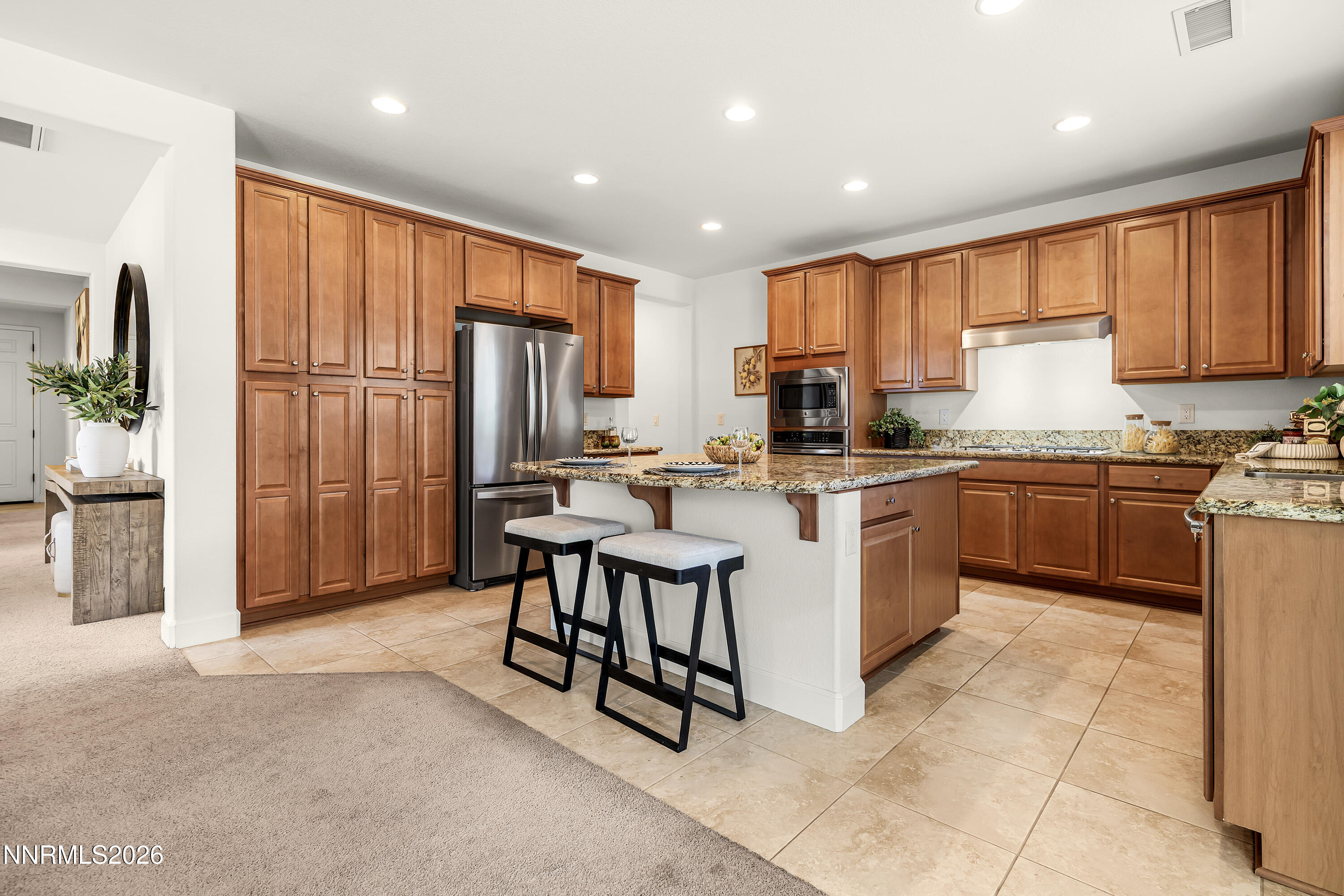 10150 Barrel Racer Drive Reno, NV 89521 - Photo 17 of 64 a kitchen with stainless steel appliances granite countertop a refrigerator sink and cabinets