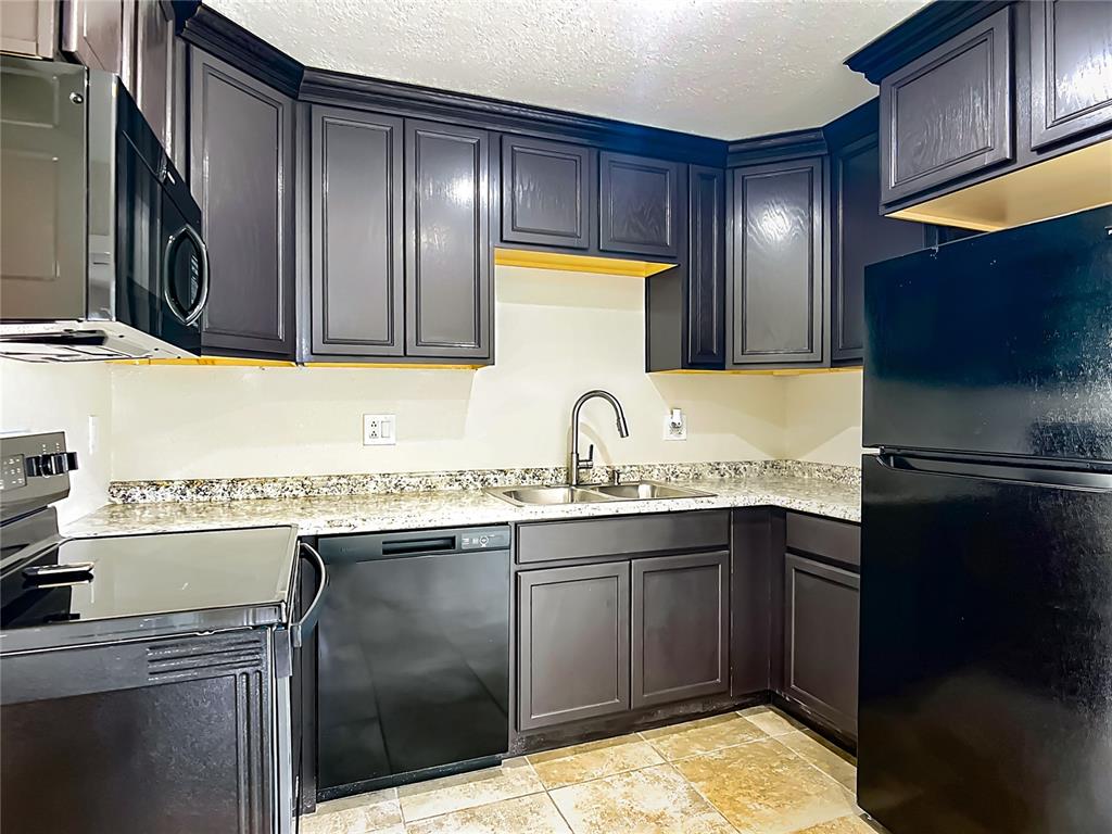 6707 Sierra Terrace New Port Richey, FL 34652 - Photo 15 of 50 a kitchen with stainless steel appliances granite countertop a sink stove and refrigerator