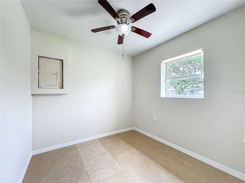 6707 Sierra Terrace New Port Richey, FL 34652 - Photo 16 of 50 an empty room with a window and a ceiling fan