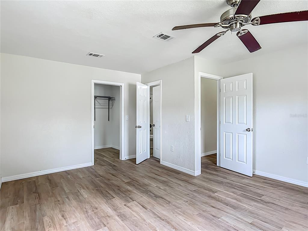 6707 Sierra Terrace New Port Richey, FL 34652 - Photo 22 of 50 an empty room with wooden floor closet and windows