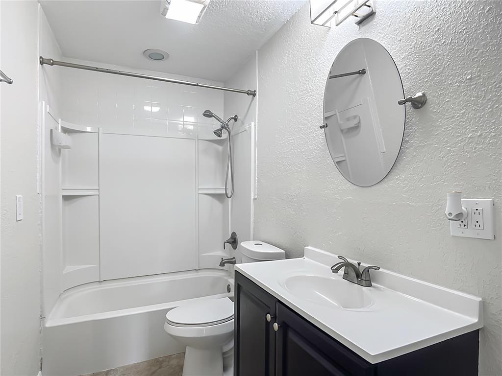 6707 Sierra Terrace New Port Richey, FL 34652 - Photo 23 of 50 a bathroom with a sink toilet and shower
