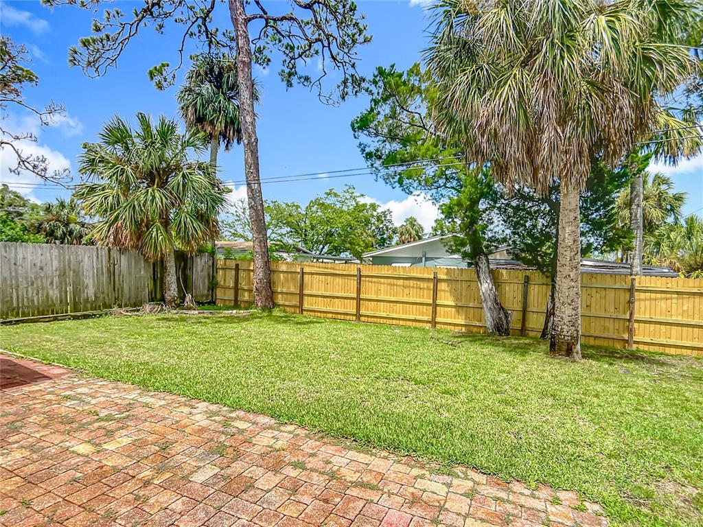 6707 Sierra Terrace New Port Richey, FL 34652 - Photo 38 of 50 a view of backyard with wooden fence and a bench