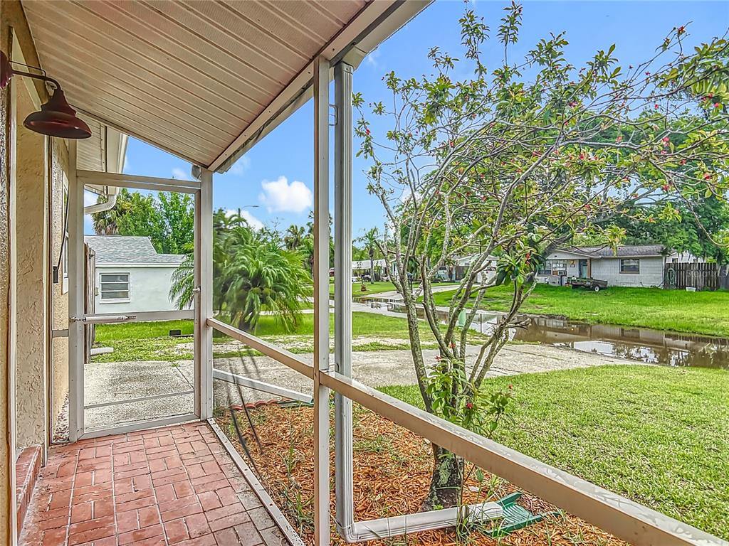 6707 Sierra Terrace New Port Richey, FL 34652 - Photo 6 of 50 a view of a porch and garden