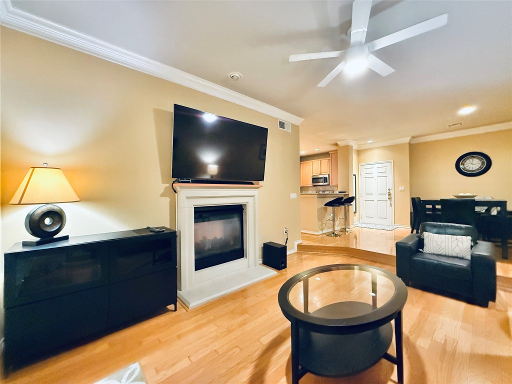 2400 McCue Road, Unit 325 Houston, TX 77056 - Photo 3 of 30 a living room with a fireplace furniture and a flat screen tv