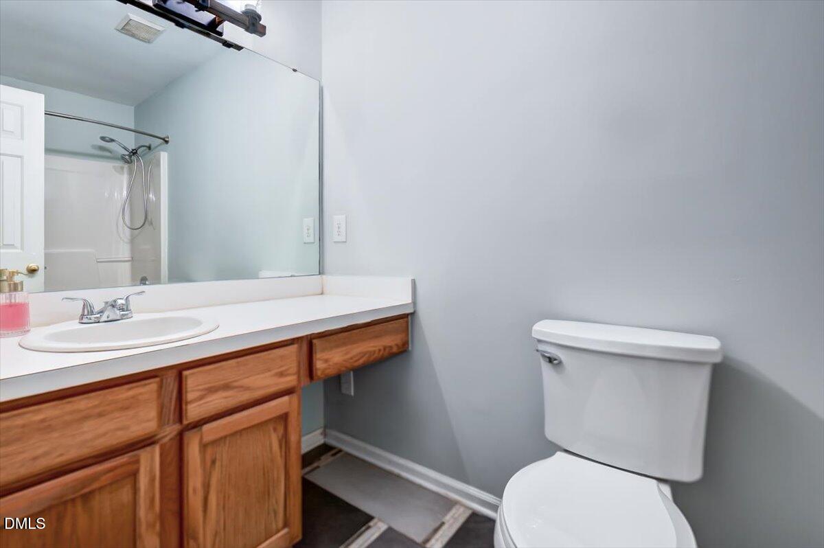 103 Kingsmill Road Cary, NC 27511 - Photo 13 of 30 a bathroom with a toilet a sink and mirror