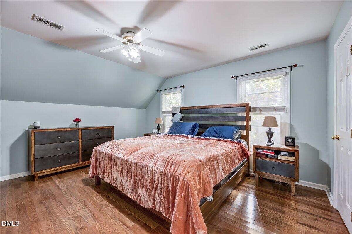 103 Kingsmill Road Cary, NC 27511 - Photo 14 of 30 a bedroom with a bed and a dresser