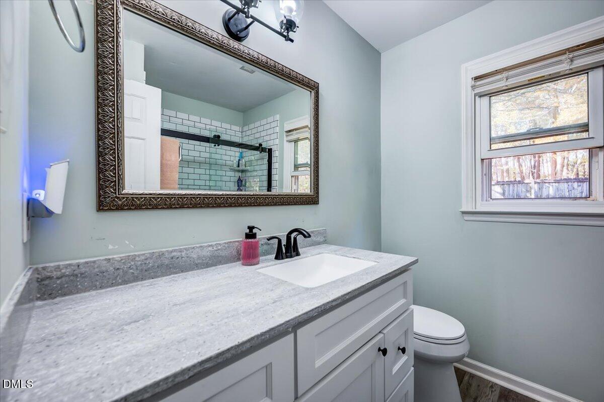 103 Kingsmill Road Cary, NC 27511 - Photo 17 of 30 a bathroom with a granite countertop toilet sink and mirror