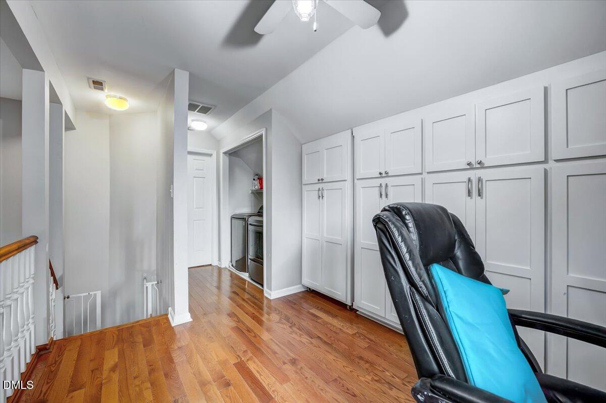 103 Kingsmill Road Cary, NC 27511 - Photo 20 of 30 a view of a hallway with wooden floor and furniture