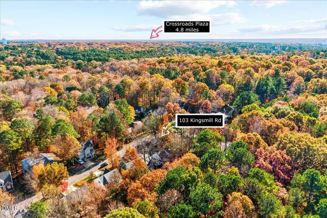 an aerial view of a house with a yard and garden