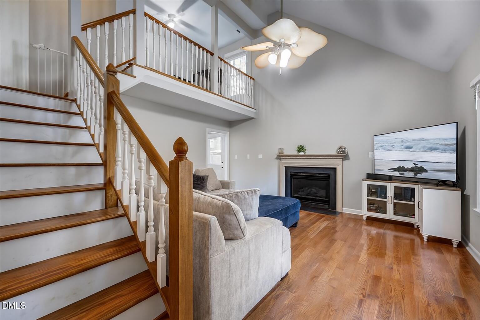 103 Kingsmill Road Cary, NC 27511 - Photo 3 of 30 a view of a livingroom with furniture a fireplace wooden floor and staircase