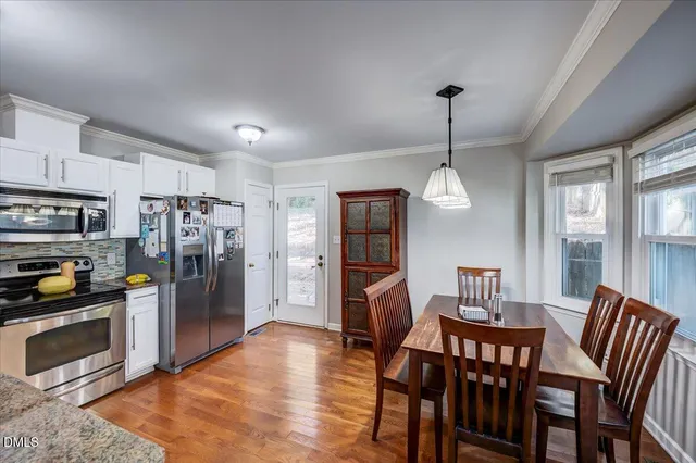 a view of a dining room with furniture window and wooden floor
