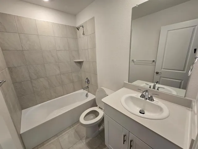 a bathroom with a sink a bathtub and a mirror