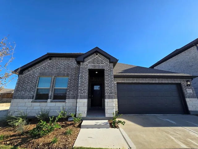 a front view of a house with yard