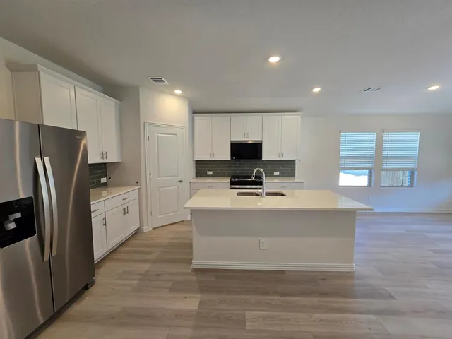 a view of kitchen with sink and wooden floor