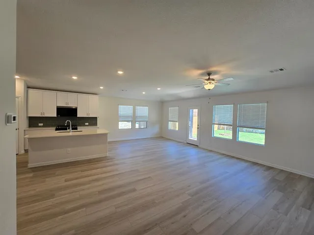 a kitchen with stove and cabinets