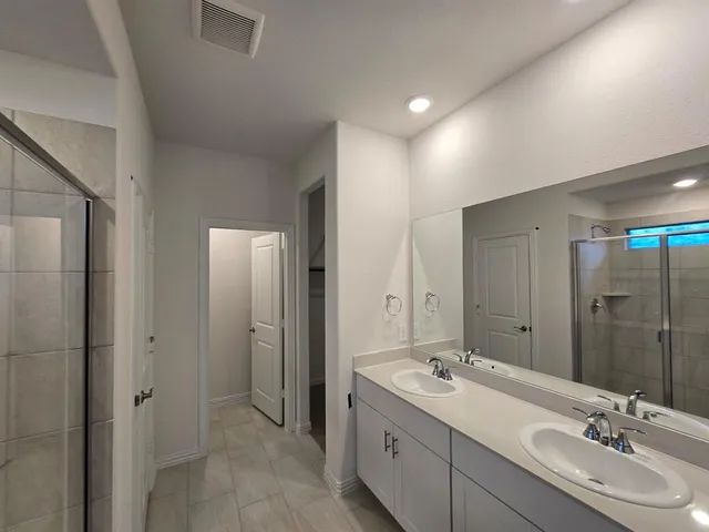 a kitchen with stainless steel appliances a stove top oven a refrigerator a sink and a refrigerator