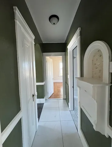 a view of a hallway with entryway dining room and front door
