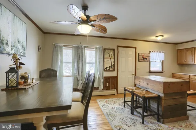 a view of a dining room with furniture and a chandelier