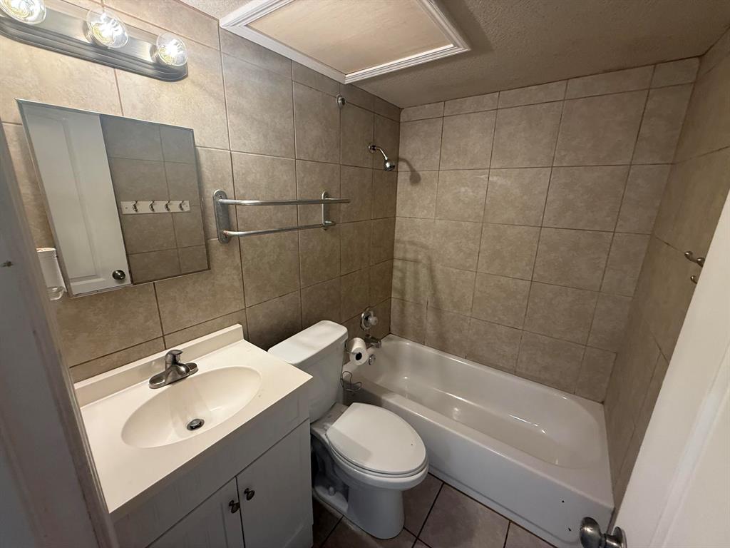 312 West Rentz Street, Unit 93 Weatherford, TX 76086 - Photo 14 of 15 Bathroom featuring a white vanity with integrated sink, chrome faucet, and storage cabinet