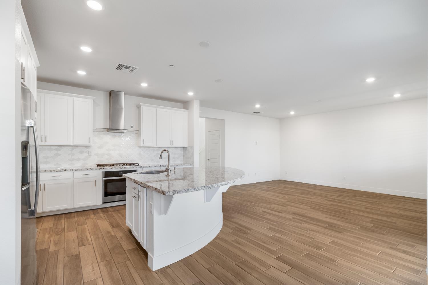 4263 Orpheus Circle Rancho Cordova, CA 95742 - Photo 11 of 51 a kitchen with stainless steel appliances granite countertop a stove top oven a sink and white cabinets