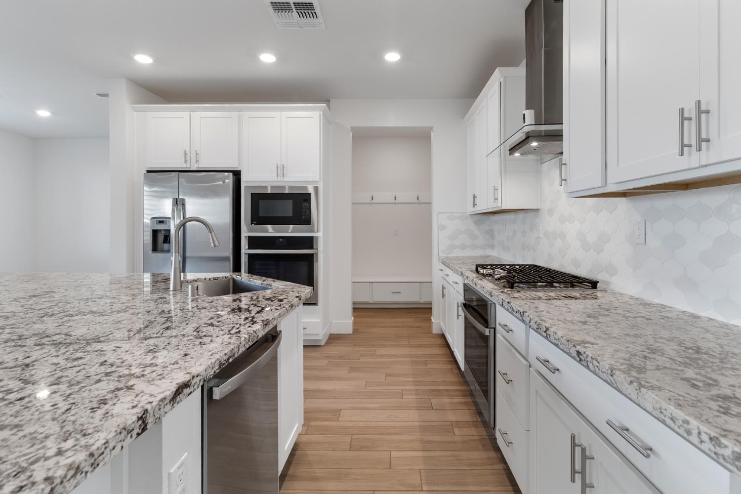 4263 Orpheus Circle Rancho Cordova, CA 95742 - Photo 12 of 51 a large kitchen with stainless steel appliances granite countertop a stove top oven a sink and dishwasher