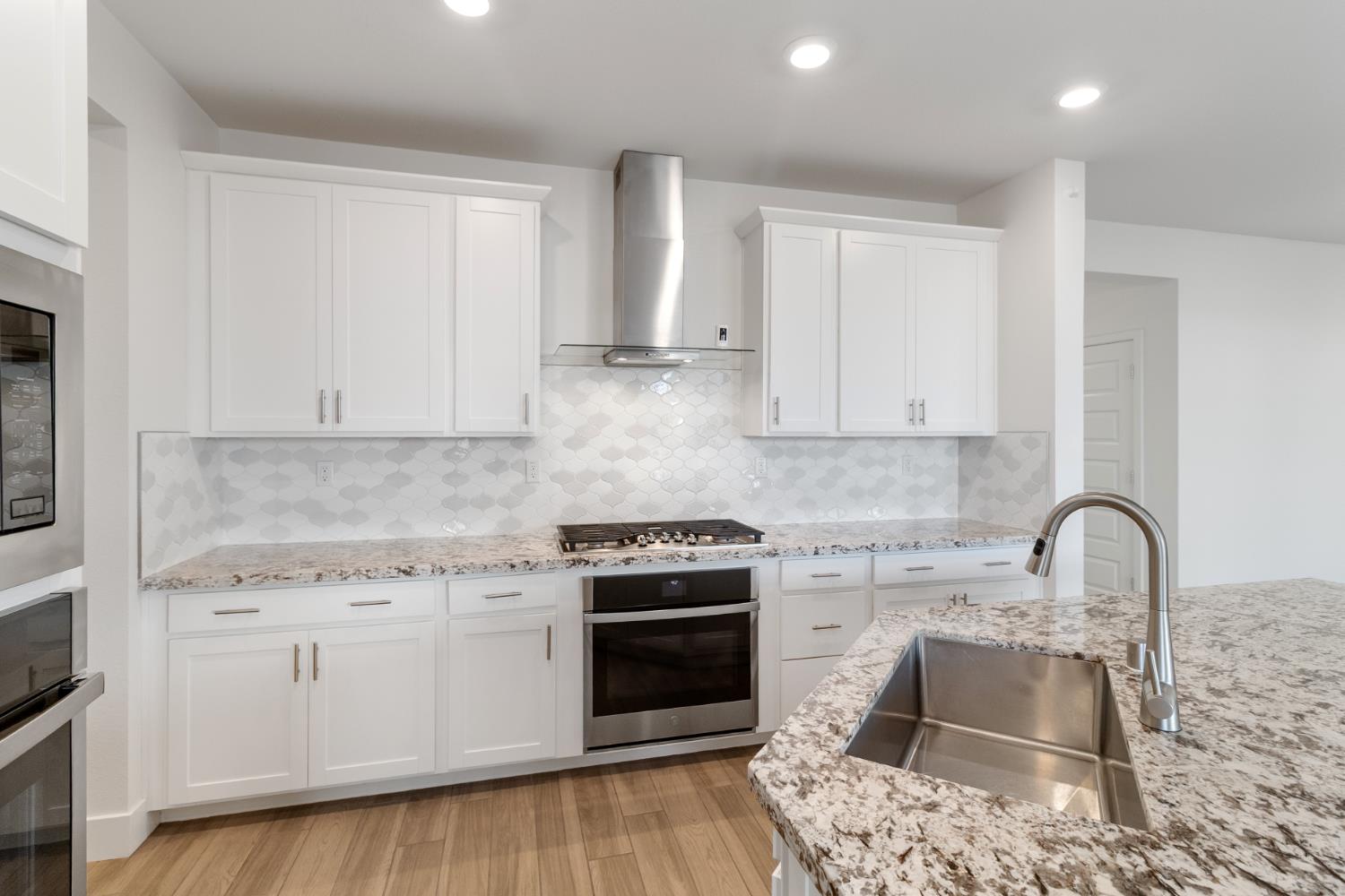 4263 Orpheus Circle Rancho Cordova, CA 95742 - Photo 13 of 51 a kitchen with granite countertop a stove sink and cabinets