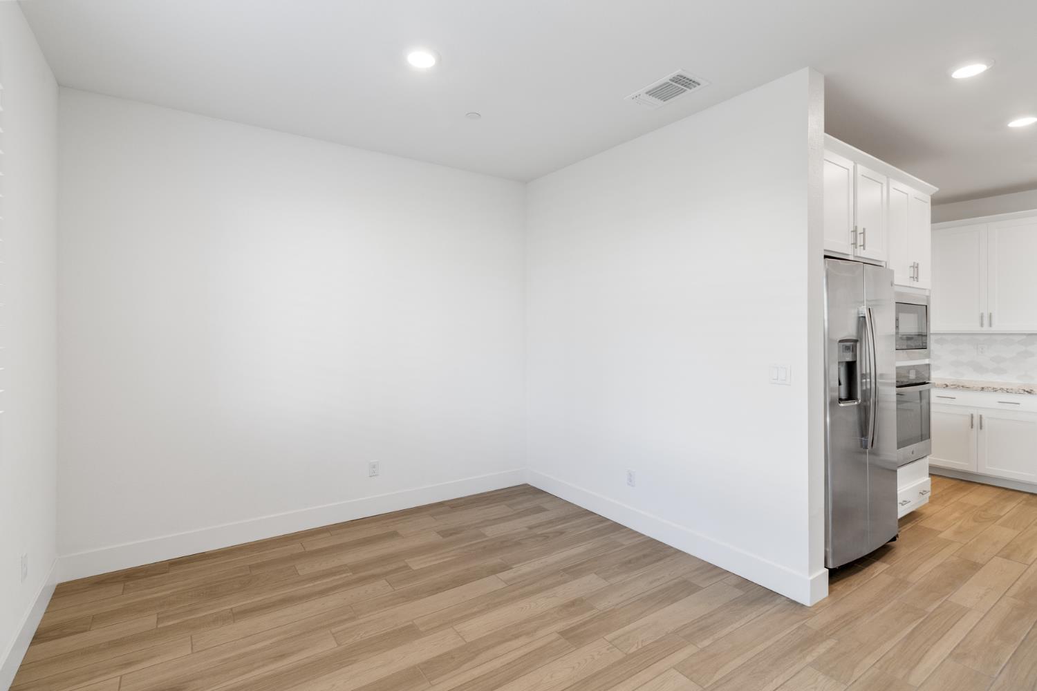 4263 Orpheus Circle Rancho Cordova, CA 95742 - Photo 20 of 51 a view of a kitchen with wooden floor and electronic appliances