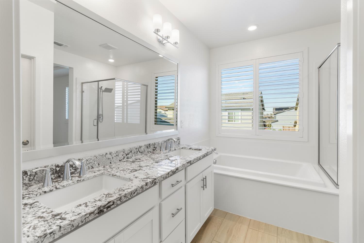 4263 Orpheus Circle Rancho Cordova, CA 95742 - Photo 36 of 51 a bathroom with a granite countertop sink mirror double vanity tub and shower