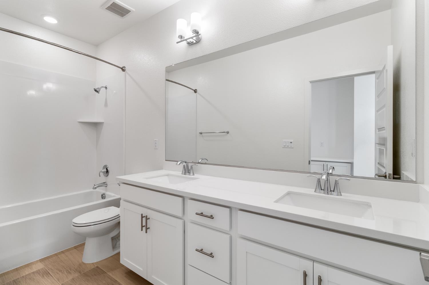 4263 Orpheus Circle Rancho Cordova, CA 95742 - Photo 45 of 51 a bathroom with a granite countertop toilet a sink and a mirror