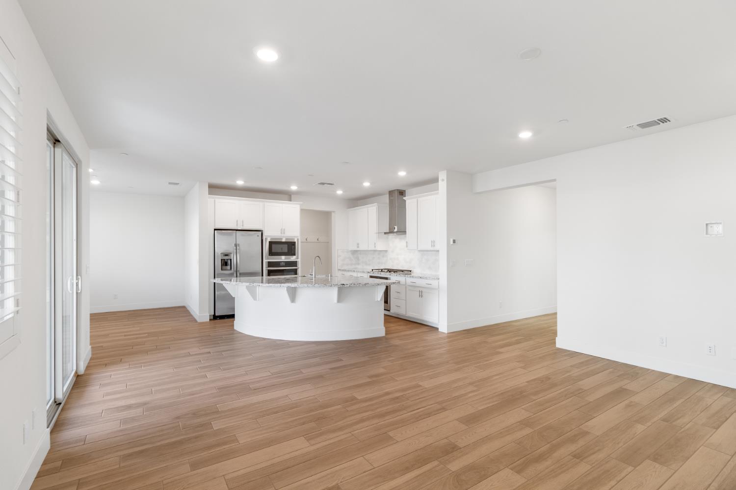 4263 Orpheus Circle Rancho Cordova, CA 95742 - Photo 6 of 51 a view of kitchen with kitchen island sink refrigerator and white cabinets