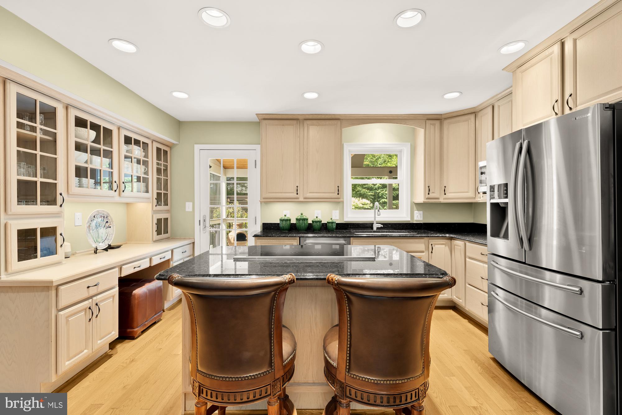 5117 Pheasant Ridge Road Fairfax, VA 22030 - Photo 11 of 59 a kitchen with stainless steel appliances a refrigerator a sink a stove a table and chairs